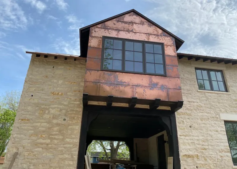 Copper metal panel facade on a stone building for Metal Roof Coating in Blair